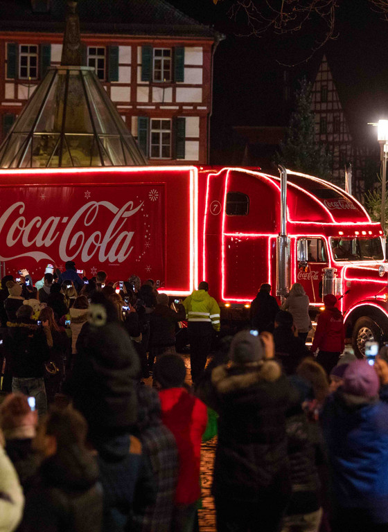 Visitors take pictures of the Coca Cola truck