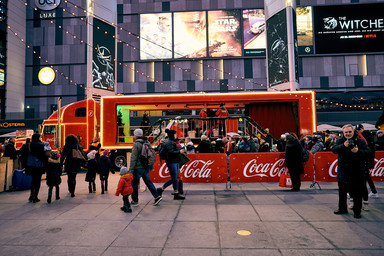 People standing next to a huge Coca Cola Truck Image 7
