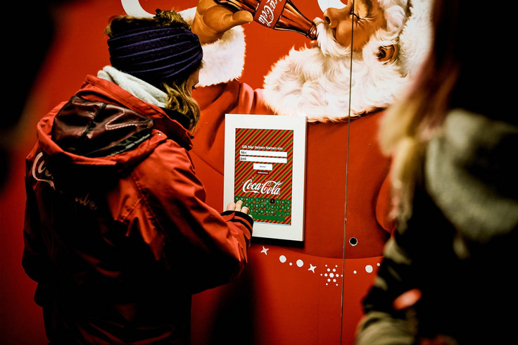 Person enters something on the Coca-Cola Christmas tablet Image 5