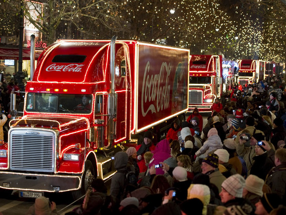 Coca-Cola Christmas Truck Tour 2017 with a crowd of people and three trucks in a row