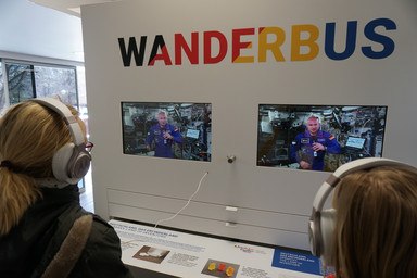 People in front of screens using headsets inside the Wanderbus Image 21