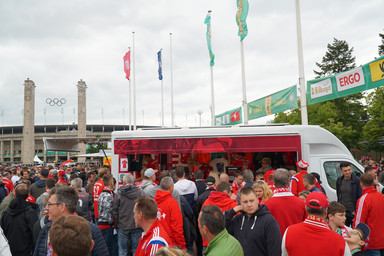 Crowd of People in front of the FC Bayern München Merchandiser Vehicle Image 5